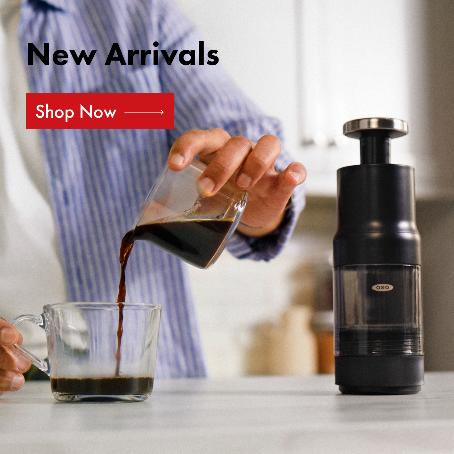 Discover this season's new arrivals Kitchen setting with someone pouring OXO Rapid Brewer's coffee concentrate into a glass mug.