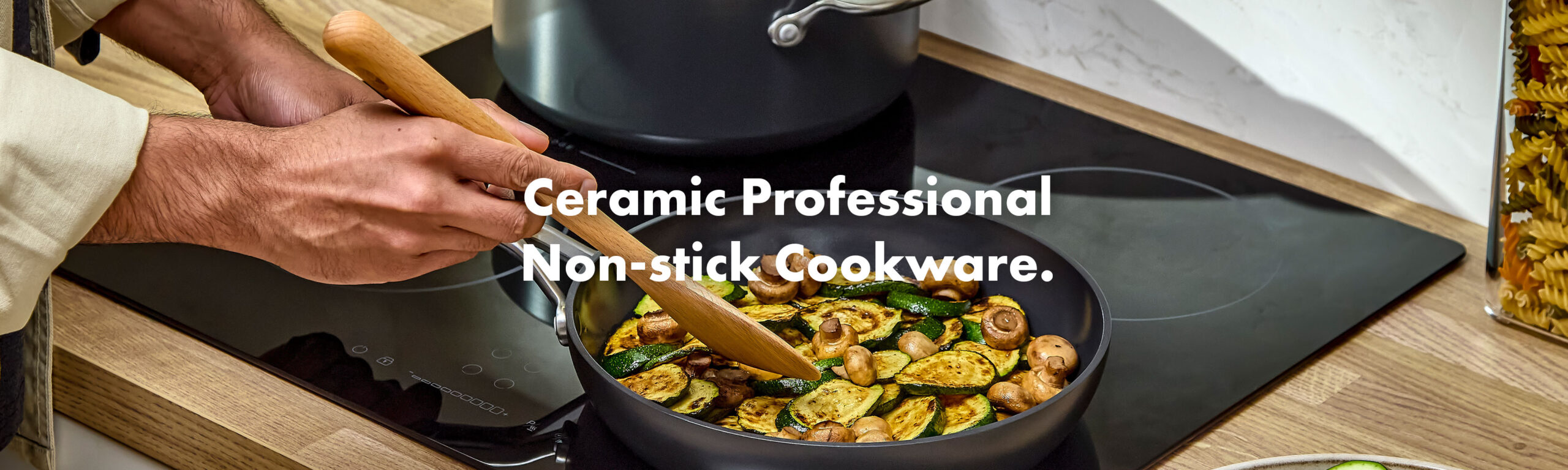 Cooking courgettes and mushrooms in an OXO Ceramic Professional non‑stick frying pan on an induction hob.