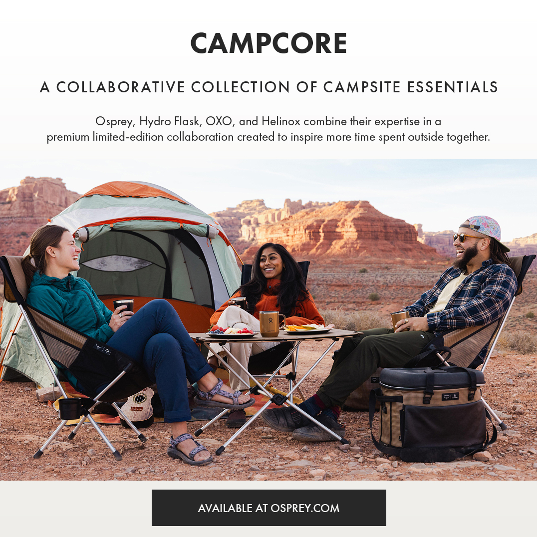 Campcore - An OXO, Osprey, Hydro Flask and Helinox collaborative collection of camping essentials Three people sitting around a foldable camping table in front of a tent, laughing with mugs in hand.